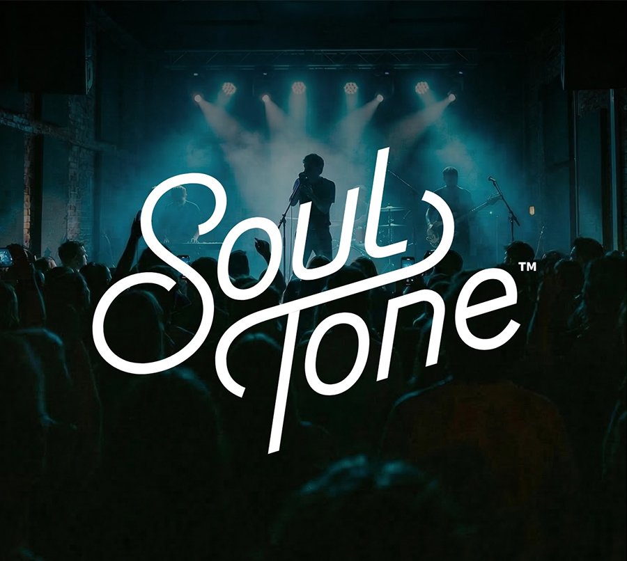 ST_ConcertImage-v2 A band performs on a dimly lit stage with blue lighting and a crowd in the foreground. The stylized text “Soul Tone” is prominently displayed over the image.