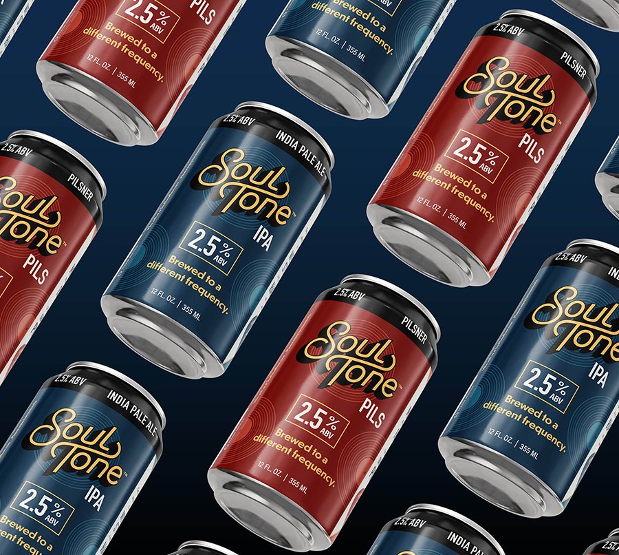 beer-wallpaper Cans of Soul Tone beer, including IPA in blue cans and Pilsner in red cans, are arranged in a diagonal pattern on a dark background. Each can displays 2.5% ABV and the phrase Brewed to a different frequency.