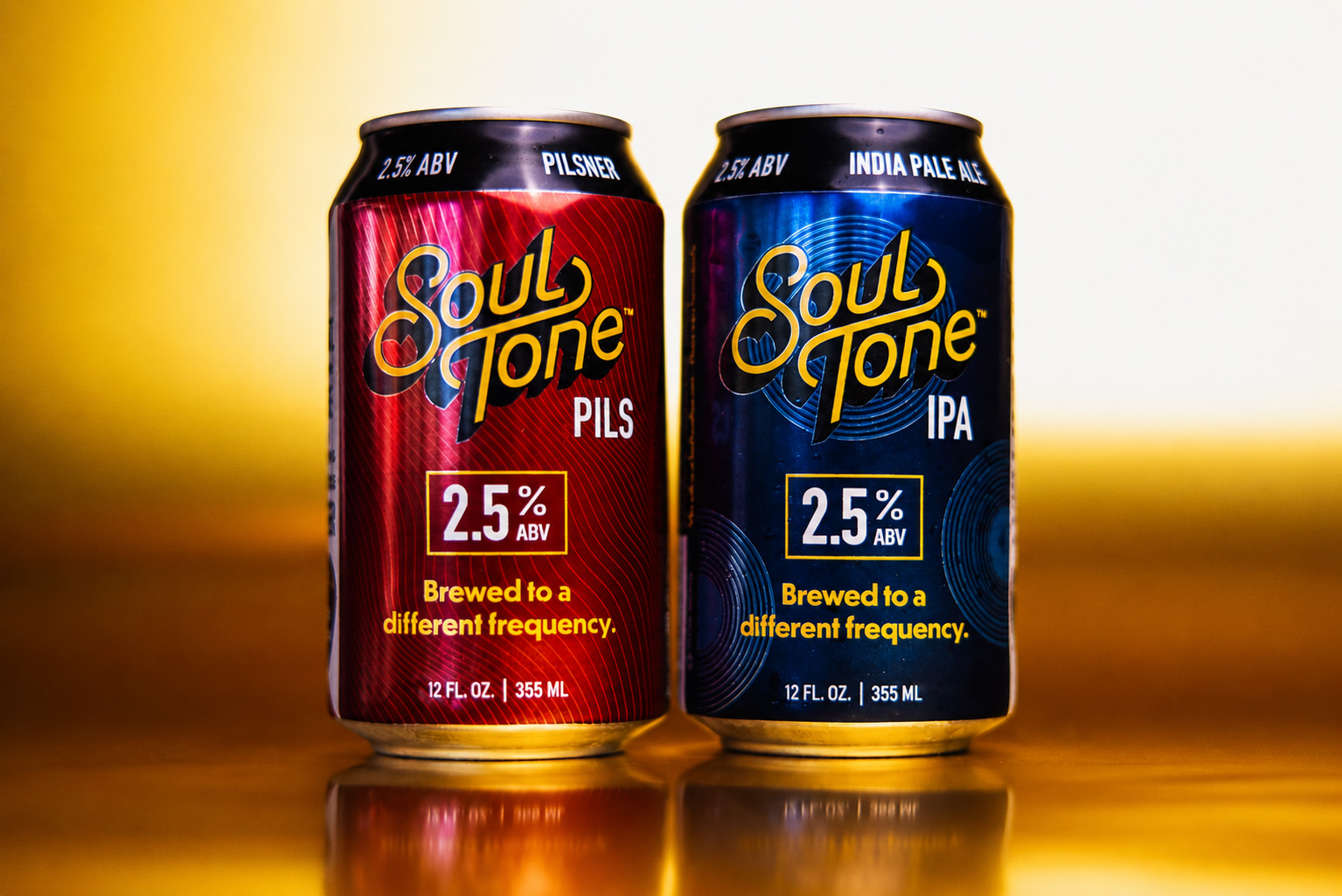 two-cans-gold Two cans of Soul Tone beer, one labeled Pils and the other IPA, both with 2.5% ABV, on a gold background. The tagline reads, Brewed to a different frequency..